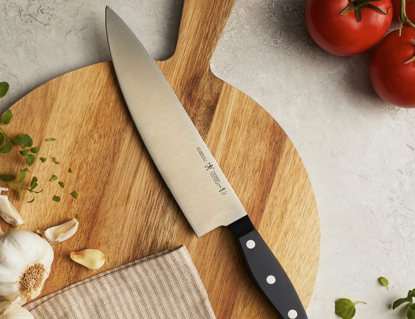 Henckels Statement 15-Piece Knife on top of cutting board